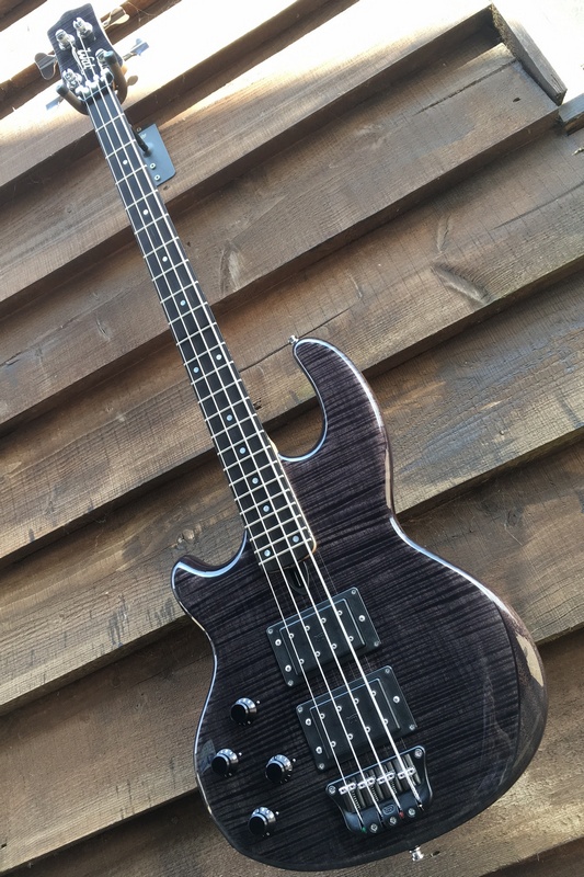 Left-handed Mk2 with flame maple facings, a gloss trans. black finish, and an ebony fingerboard.