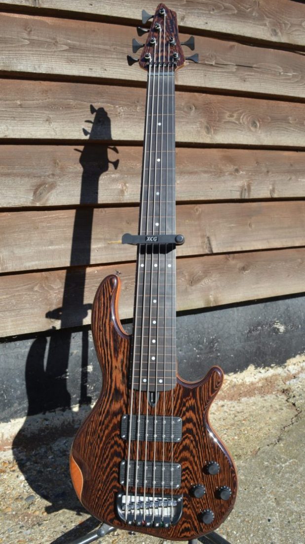6-string Mk3 with wenge facings, matching head veneer, clear gloss body, a lined fretless fingerboard and black tuners & retainer.