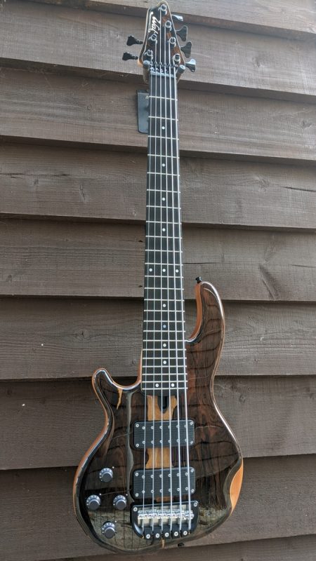 Left handed 6-string Mk3 with ziricote facings, matching head veneer, clear gloss body and black tuners & retainer.